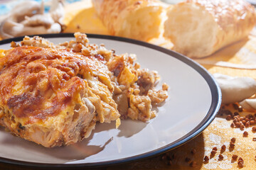 baked chicken with cheese in a white plate