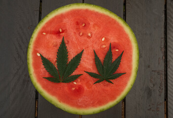 Red sweet seedless melone with green marijuana leaf