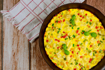 Roasted vegetable stuffed omelette with red and green bell peppers.