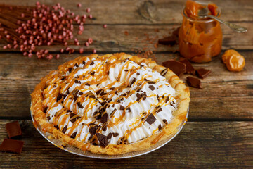 Homemade pie with wipped cream and caramel sauce.
