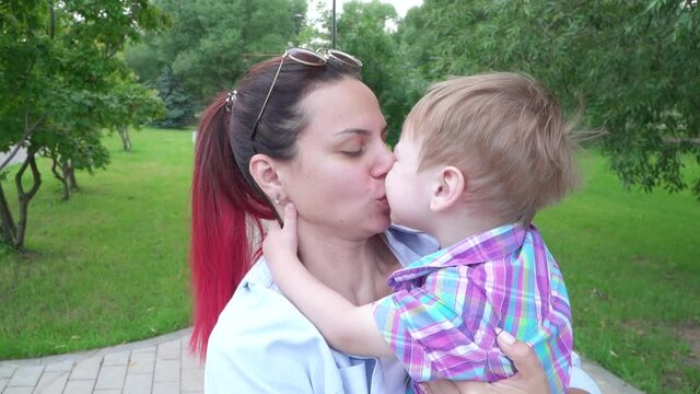 The boy kisses his mother