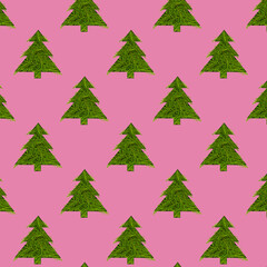 Seamless pattern with green christmas trees on a pink background. Minimal composition pattern background of Christmas trees. New year and Christmas concept.