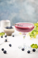Homemade antioxidant summer blueberry smoothie in a glass on white table