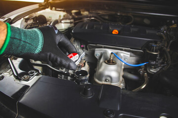 Mechanics man is opening radiator cap of car engine