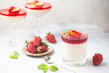 Italian panna cotta dessert with strawberry sirup and mint leaf