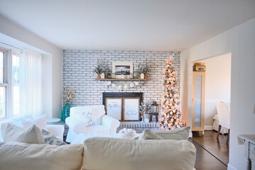 A white holiday decorated living room in an american home