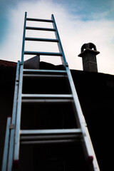 Metal ladder at the side of the house. Roof repair