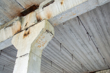 hall of a destroyed building, gray concrete walls and supports,