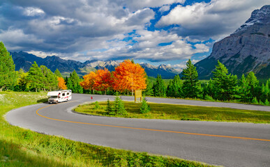 Recreational Vehicle Motorhome Driving on Autumn Highway In Fall Beautiful Mountains