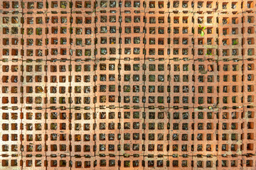 old brick with weed in space as floor for a garage entrance