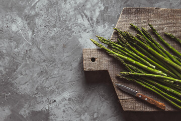 Asparagus on a cutting board. Healthy food, health on a concrete background.