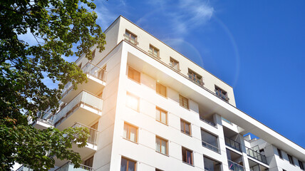 Modern apartment building. Balconies at apartment residential building. Residential architecture. Glass surface with Glass surface with sunlight..