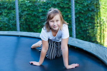 Girl jumps and plays on trampoline