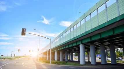 Modern road and road infrastructure. Empty road background in the city. Landscape with sunlight.