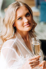 Portrait of a luxurious blonde with a glass of champagne in hand