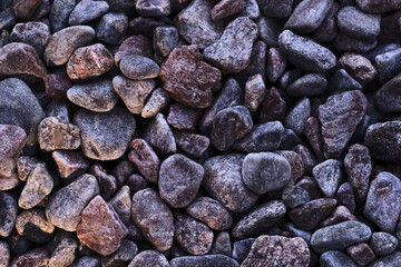 Abstract background from different sea stones on the coast.Summer rest concept.Backdrop with copy space.