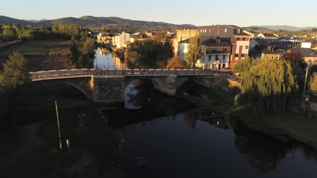 River and bridge in Cacabelos, village of Leon. Spain. Camino de Santiago. Aerial Drone Footage
