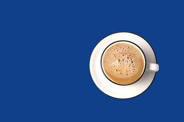 A cup of coffee isolated on classic blue background .
