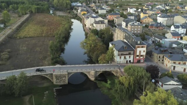 River and bridge in Cacabelos, village of Leon. Spain. Camino de Santiago. Aerial Drone Footage