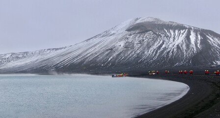 Antarctica, deception island, tourists evacuating on boat volcanic crate, storm