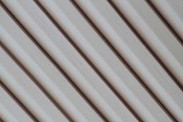 Obraz premium Light white curtain backdrop close-up modern plastic shutter blinds in office room home plastic panels texture background.