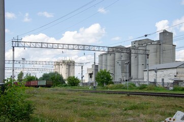 large cement plant. Cement plant near the railway. Cement production architecture.