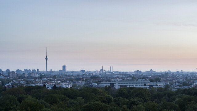 Berlin cityscape and Television Tower beyond Volkspark Friedrichshain park treetops, Germany