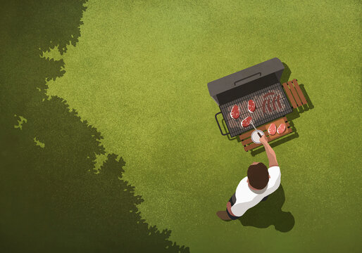 View from above man barbecuing steaks at grill in backyard