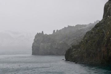 Antarctica, deception island, snow storm, volcanic black stone, apocalyptic