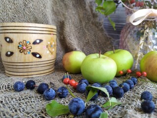Still life yellow apple walfle pastrries with cream red and blue berries on the white lace napkin on the black wooden background