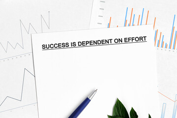 Success is dependent on effort document with graphs, diagrams and blue pen