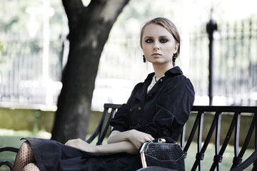 Fototapeta na wymiar woman sitting on a bench in park