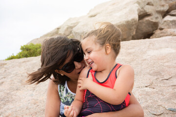 JOYFUL MOM AND DAUGHTER IN THE MOUNTAIN