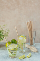 Glass of cucumber cocktail or mocktail, refreshing summer drink with crushed ice and sparkling water on a wooden background