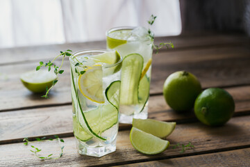 Glass of cucumber soda drink on wooden table. Summer healthy detox infused water, lemonade or cocktail background. Low alcohol, nonalcoholic drinks, vegetarian or healthy diet concept