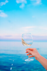 Glass of white wine on tropical beach