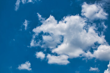Beautiful blue sky with with light puffy cirrus clouds background