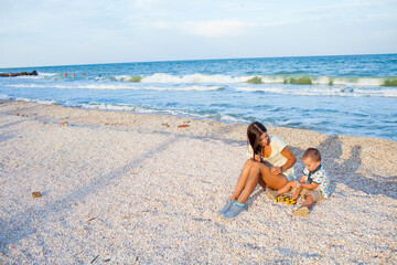 Happy mother with 2 years old son at vacation by the sea