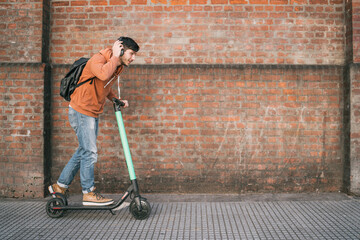 Young man driving electric scooter. © Mego-studio