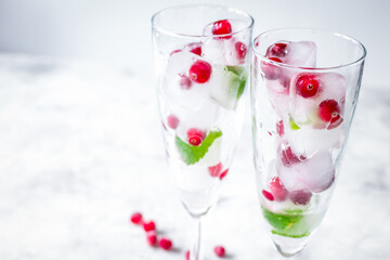 fresh cranberry in ice cubes in glasses on white background mock-up