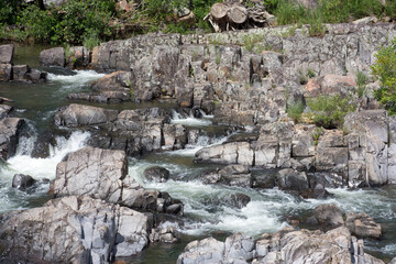 Fototapeta na wymiar Boulders in a rushing river.