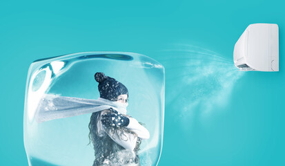 Woman frozen in an ice cube under the air jet of an air conditioner on cyan background