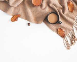 Autumn composition. Cup of coffee, plaid, autumn leaves on white background. Flat lay, top view