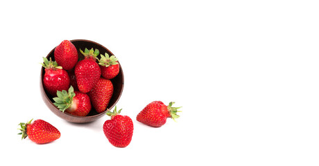 Strawberries in wooden bowl on white background