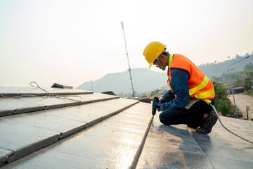 Professional technician roof install new roof on the roof top,Roofing tools,Hold the drive screw...