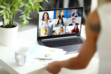 Woman talking with international colleagues using online video chat service