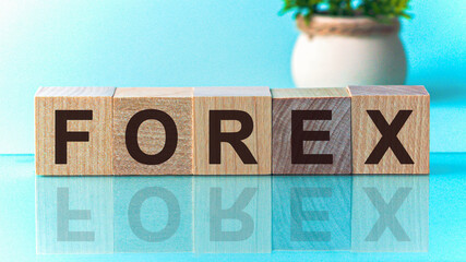 The text of the FOREX on wooden cubes, in the blu background. The written text is mirrored from the...