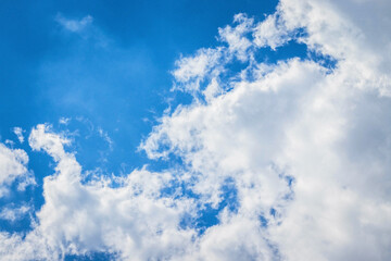 Blue sky with white fluffy clouds. Beautiful cloudscape. Sunny day. Heaven wallpaper. Texture background.