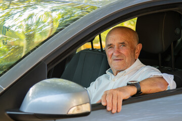 portrait of senior male driving car