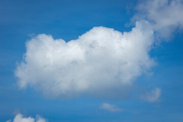 White clouds in blue sky background.